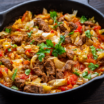 Ground beef and cabbage skillet in a black cast-iron skillet with parsley garnish