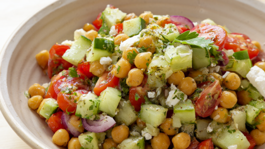 Mediterranean chickpea salad with cherry tomatoes, cucumber, red onion, feta and parsley in a lemon-oregano vinaigrette