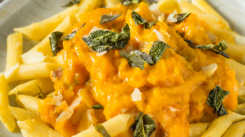 Penne pasta in creamy butternut squash sauce topped with crispy sage leaves and Parmesan