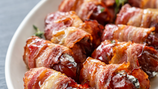 Bacon-wrapped dates stuffed with herbed goat cheese, drizzled with honey and garnished with fresh thyme
