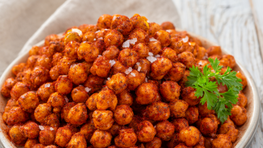 Crispy golden roasted chickpeas with smoked paprika and sea salt in a shallow ceramic bowl