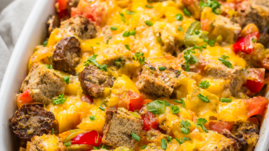 Golden-baked Christmas breakfast casserole with turkey sausage, sweet peppers and melted cheddar in a white baking dish
