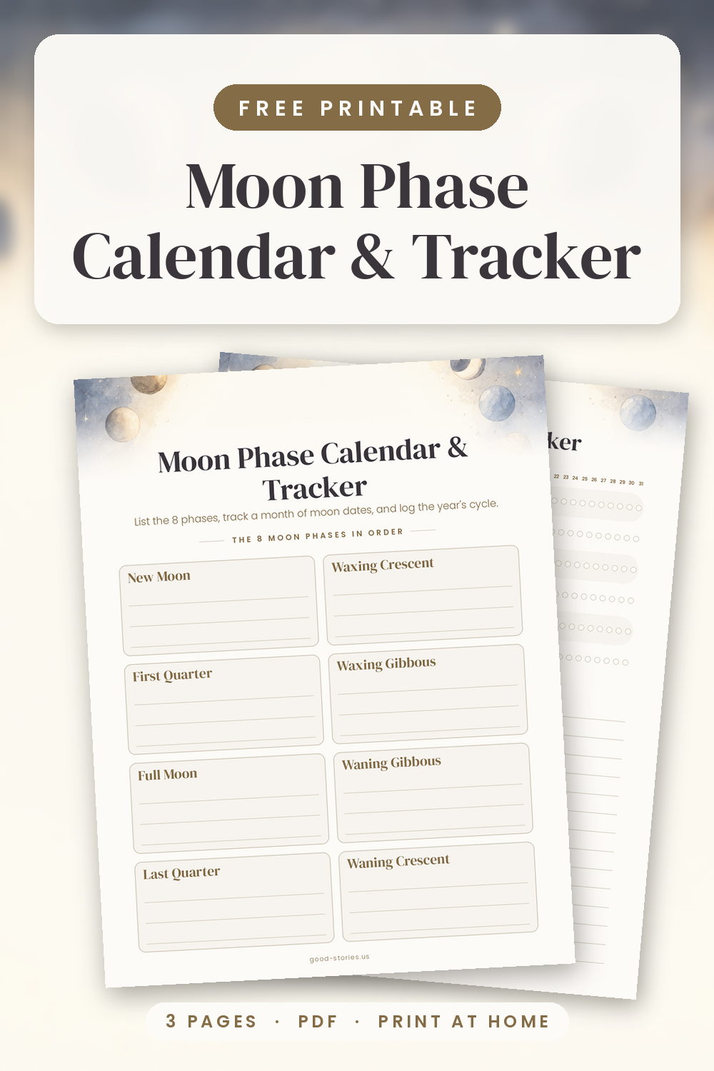 Flat-lay of two printed moon phase calendar pages on deep navy linen with a cream notebook, brass moon-phase garland, lit candle and star confetti