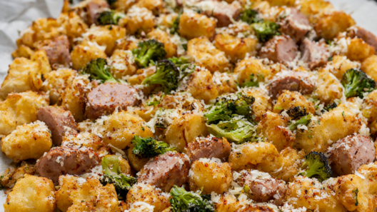 Sheet pan gnocchi with sausage and broccoli, golden and crisp on a parchment-lined pan.