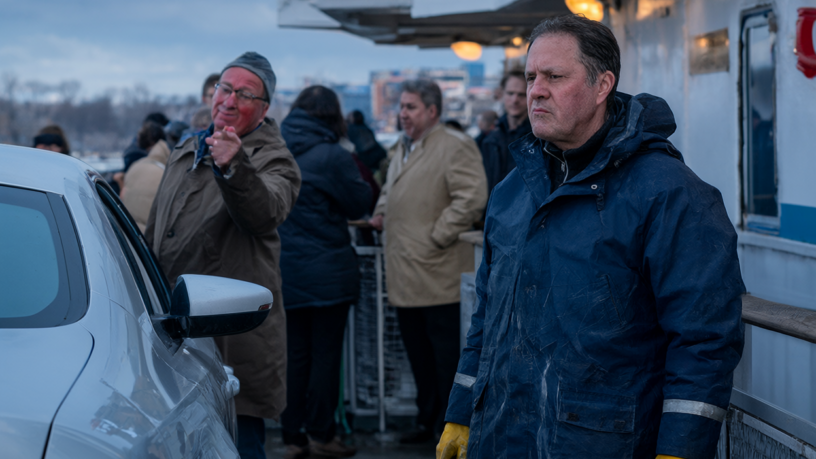 Rita, a ferry deckhand in a navy rain jacket, stands rigid on the wet car deck while an angry commuter points at the scratched door of his silver sedan and passengers watch from the rail.