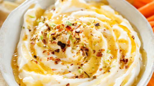 Whipped feta dip topped with chili honey, red pepper flakes and chopped pistachios, served with pita chips and carrots