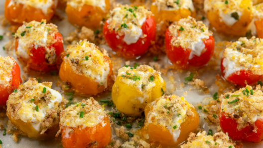 Roasted stuffed mini sweet peppers on a platter with goat cheese filling, golden panko and chives.